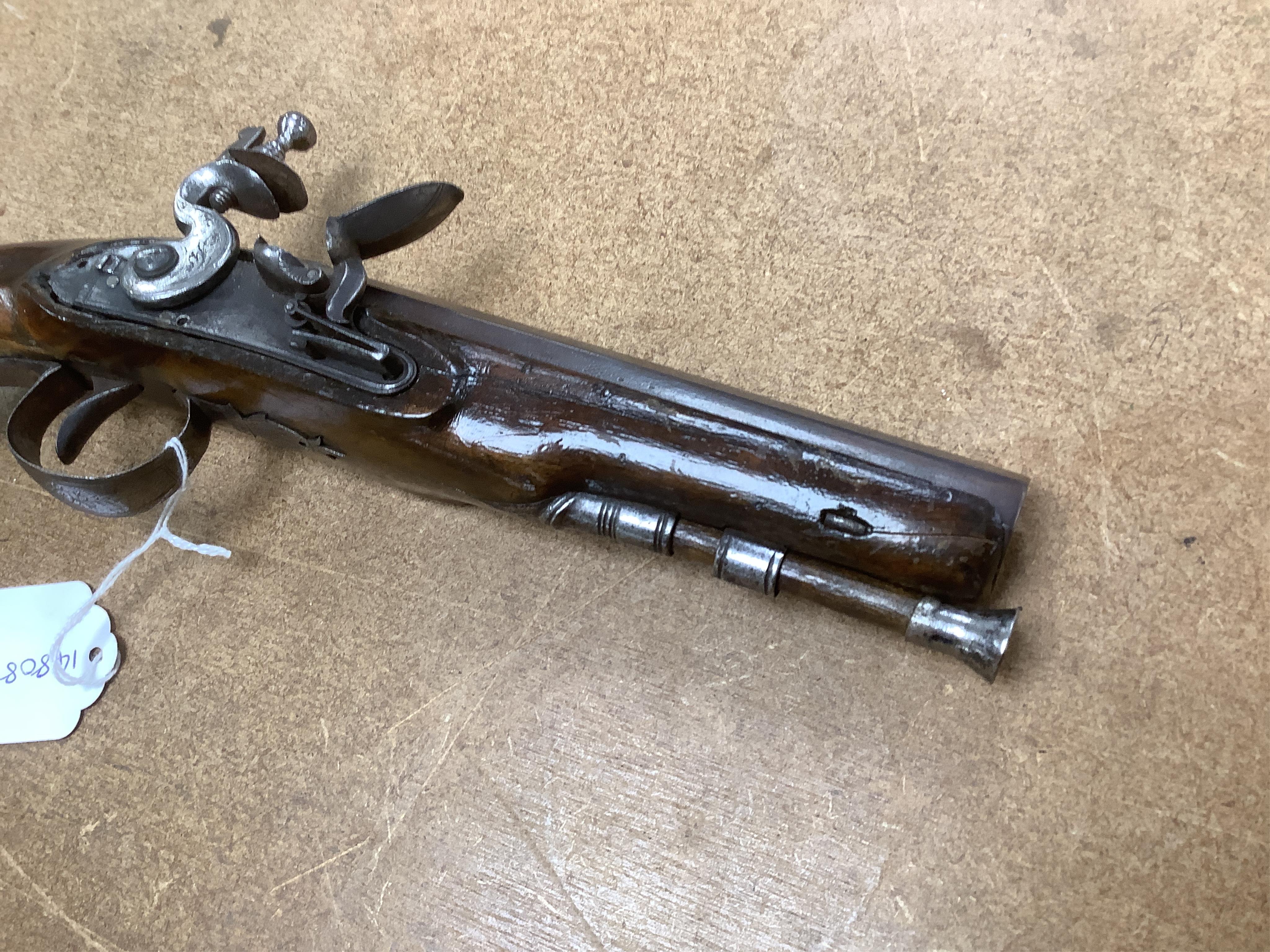 An early 19th century 12 bore fully stocked flintlock holster pistol, octagonal barrel with Birmingham proof marks, engraved iron trigger guard, iron tipped wooden ramrod, barrel 15.5cm. Condition - fair, cock replaced,